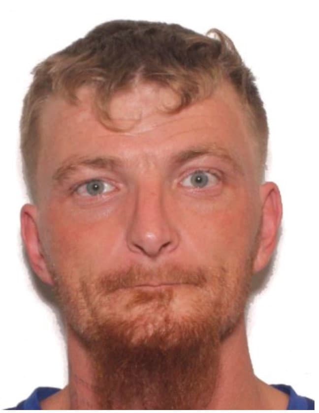 Fact Check: The suspect in the shooting is described as a white male with brown hair, last seen wearing black body armor over a blue shirt and blue pants.