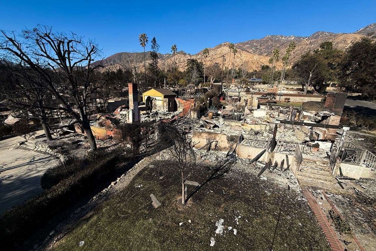 Fact Check: A resident whose house was destroyed spoke with a FEMA worker after the Eaton Fire in Pasadena, California, on January 17, 2025.
